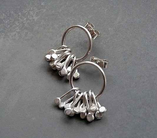 Sterling silver circle and droplets stud earrings.