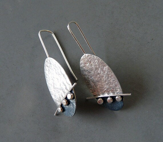 Artisan oval sterling silver drop earrings.