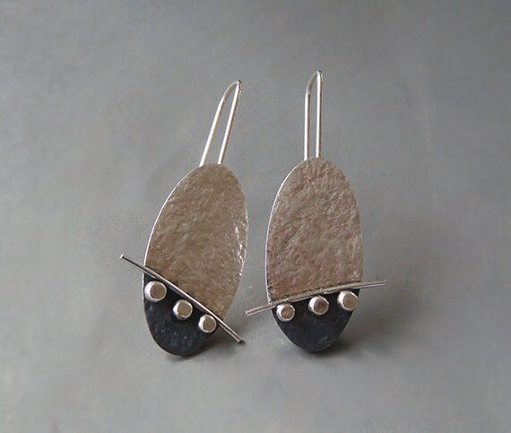 Artisan oval sterling silver drop earrings.