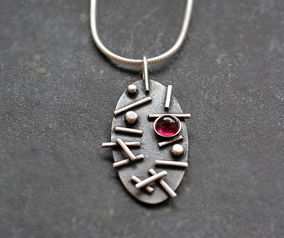 Garnet oxidised sterling silver oval necklace.