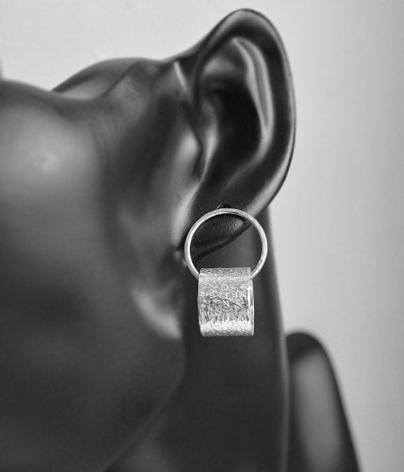 Sterling silver circle stud earrings.