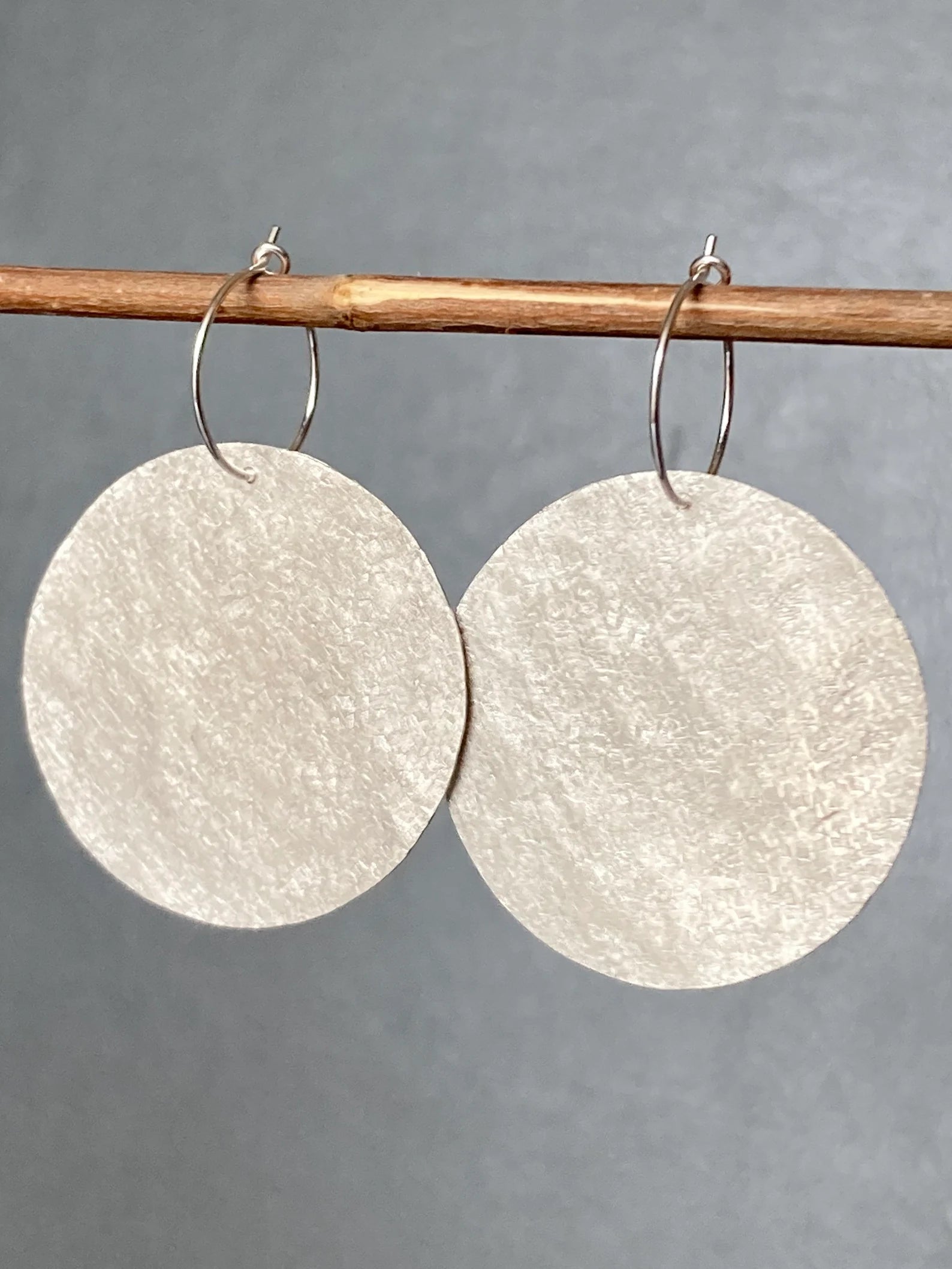 Large sterling silver textured disc hoop earrings
