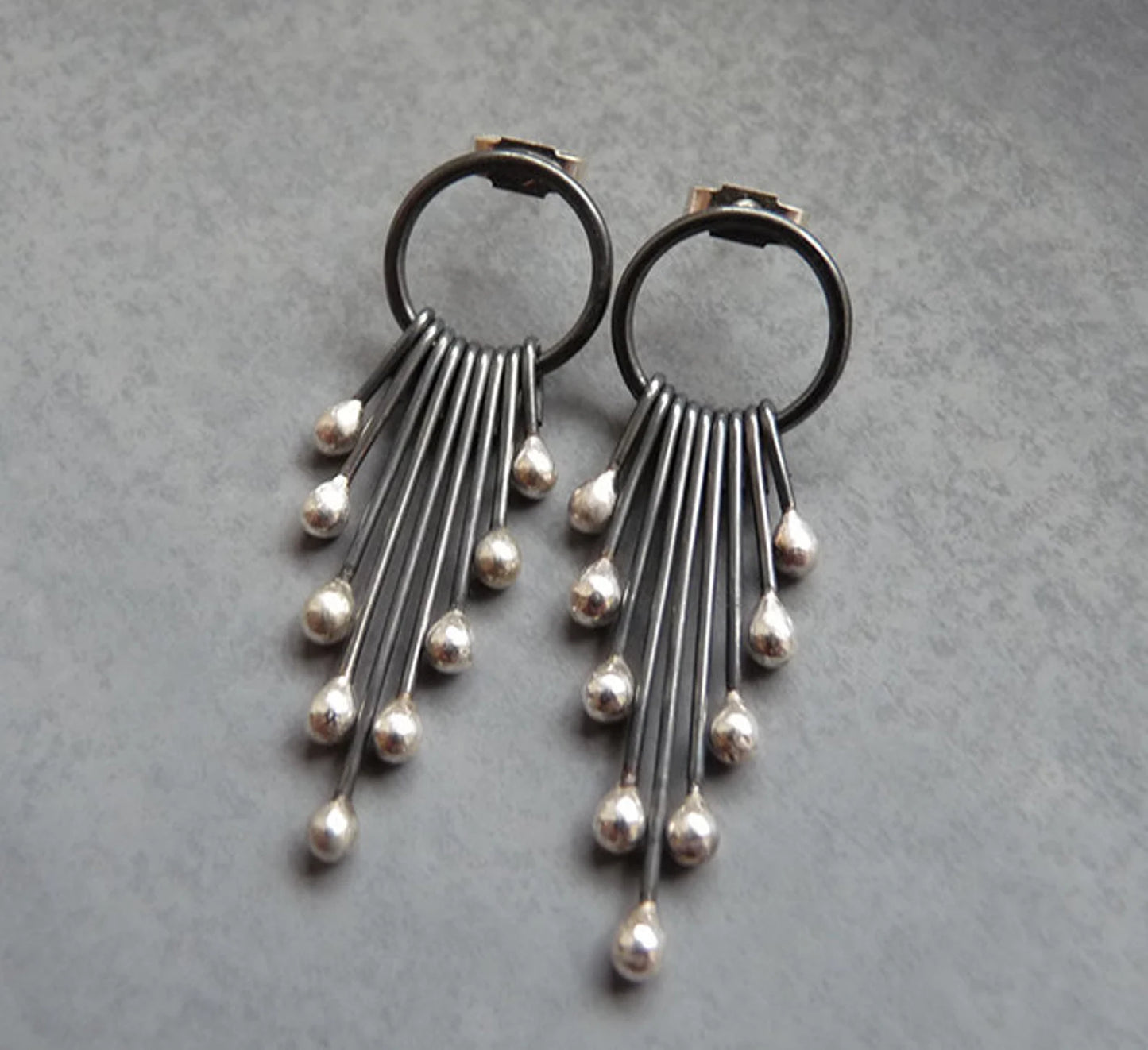 Sterling silver oxidised circle and droplets stud earrings.