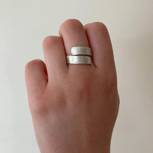 silver adjustable ring on finger