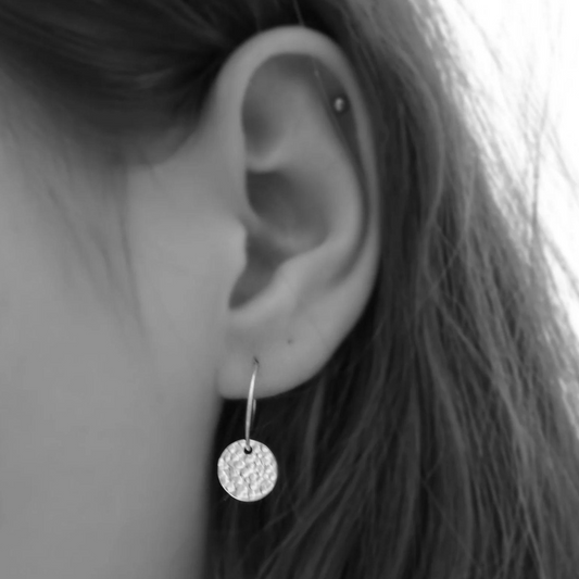 Sterling silver disc charm hoop earrings.