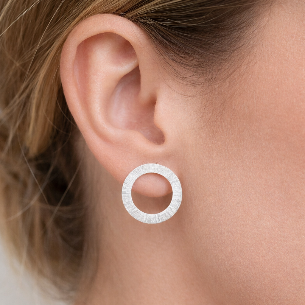 Large sterling silver circle stud earrings.
