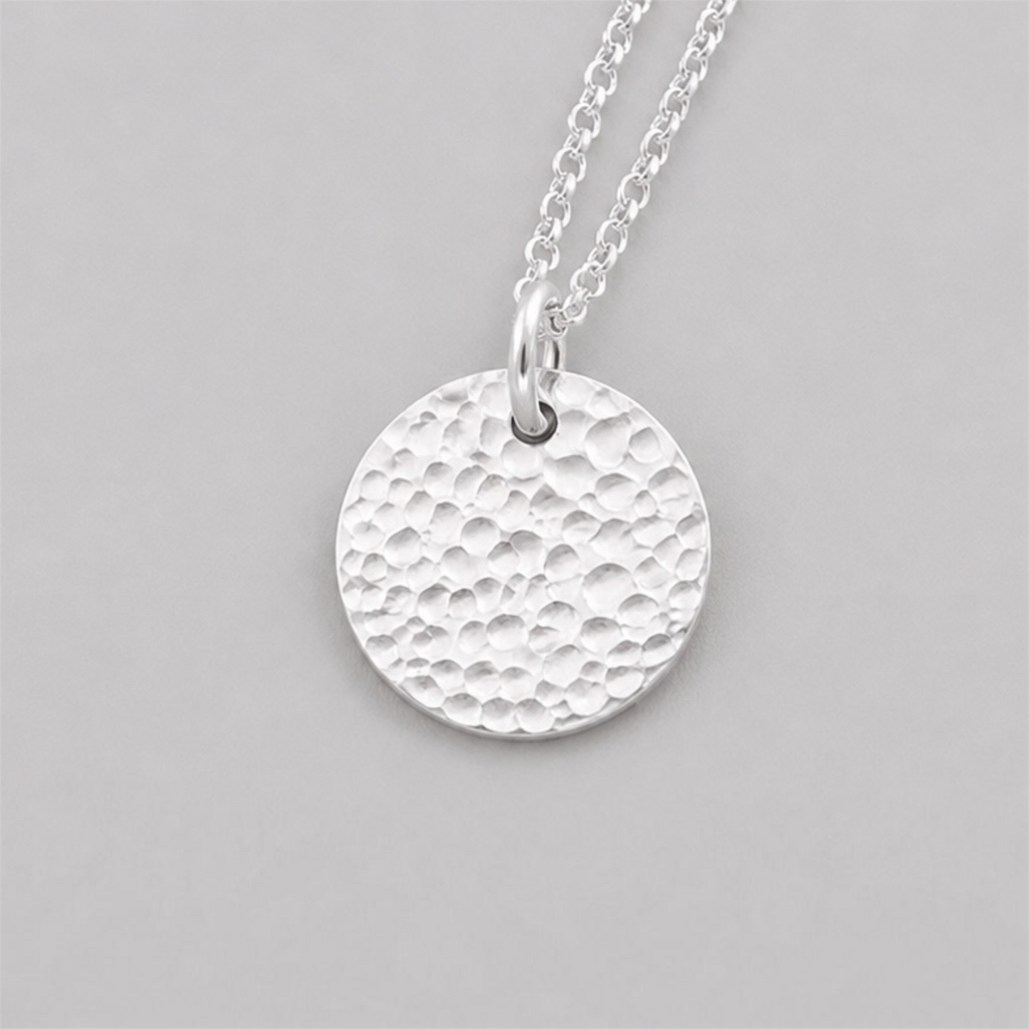 Minimalist sterling silver textured disc necklace.