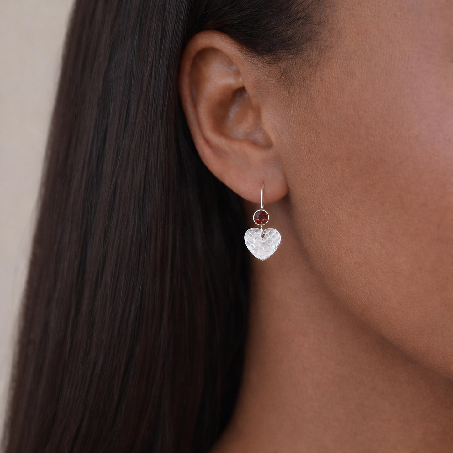 Garnet sterling silver heart dangle earrings.