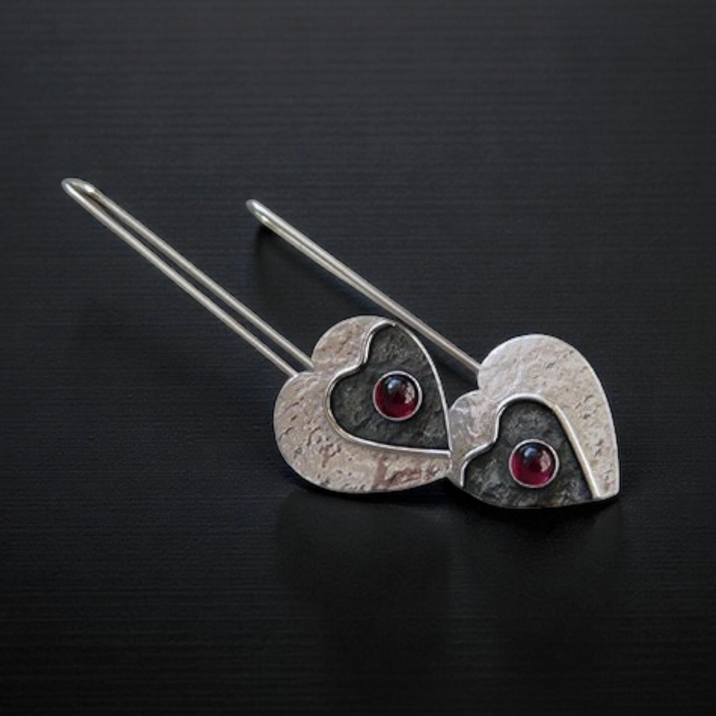 Garnet sterling silver heart earrings.