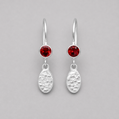 Garnet birthstone sterling silver dangle textured oval earrings.