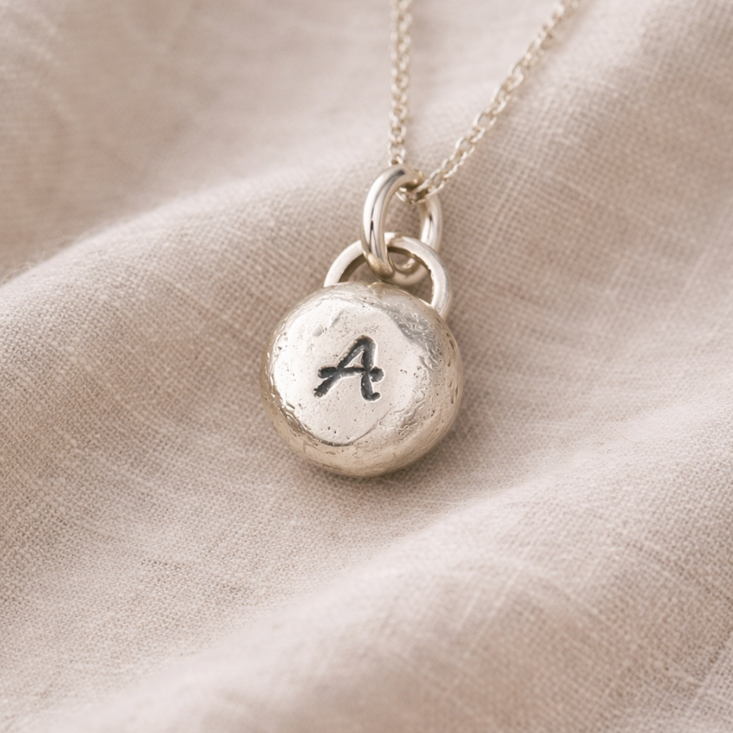 Pebble solid sterling silver personalised letter necklace.