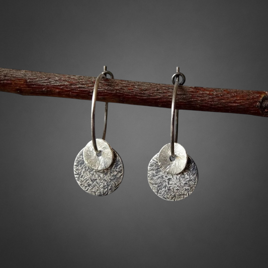 Sterling silver oxidised hammered disc hoop earrings.