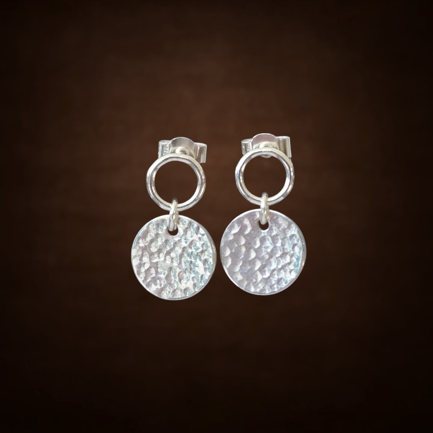 Sterling silver circle and hammered disc stud earrings.