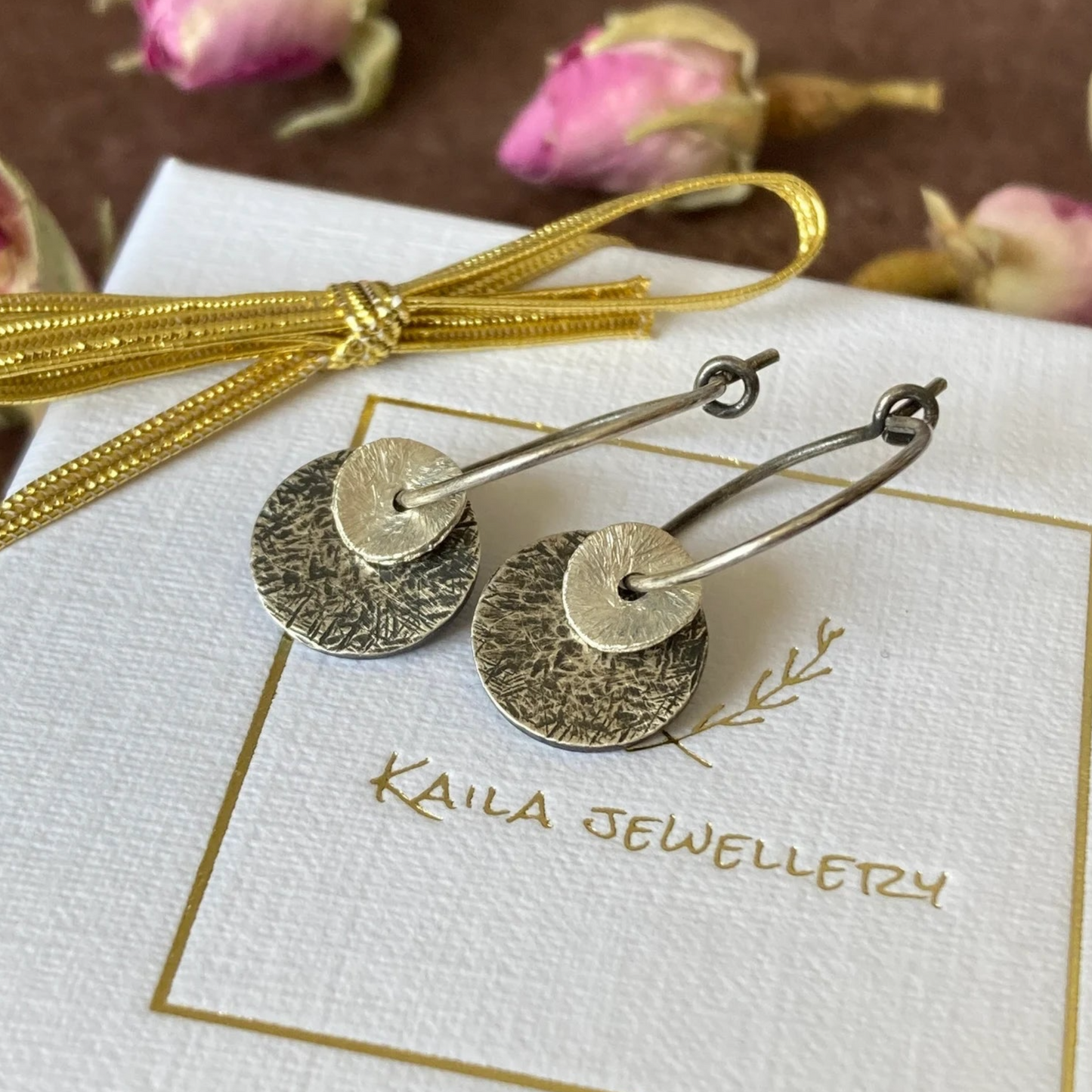 Sterling silver oxidised hammered disc hoop earrings.