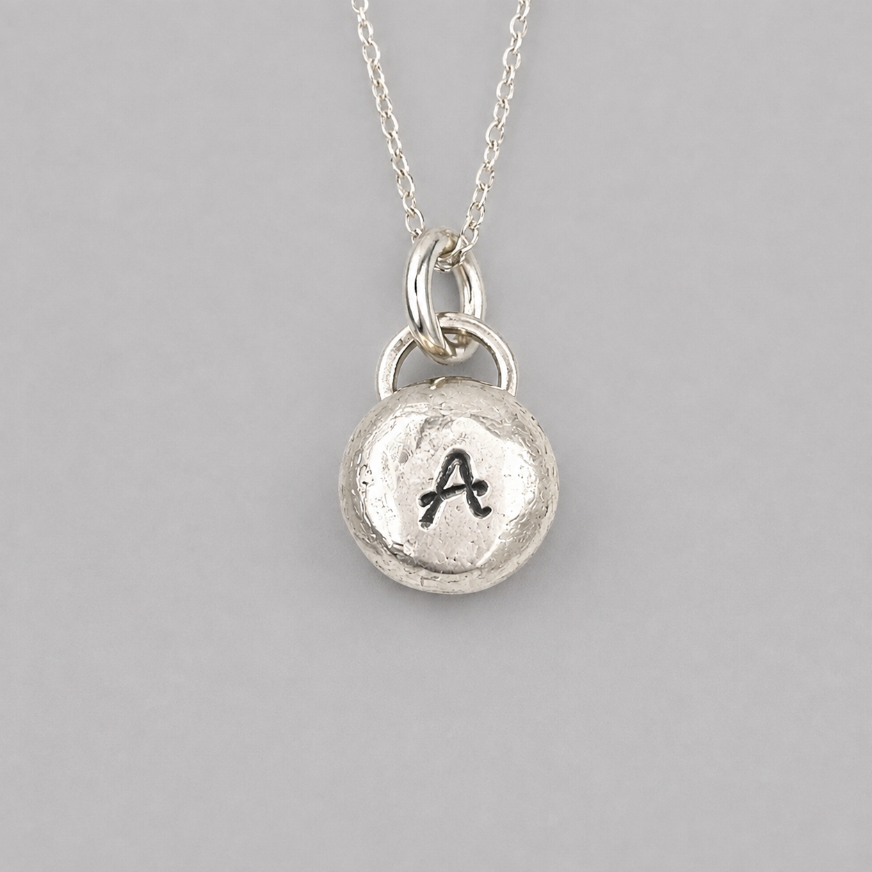 Pebble solid sterling silver personalised letter necklace.