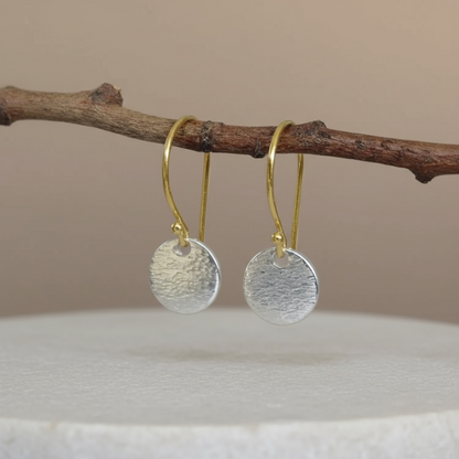 Hammered sterling silver disc and gold vermeil ear wire earrings.