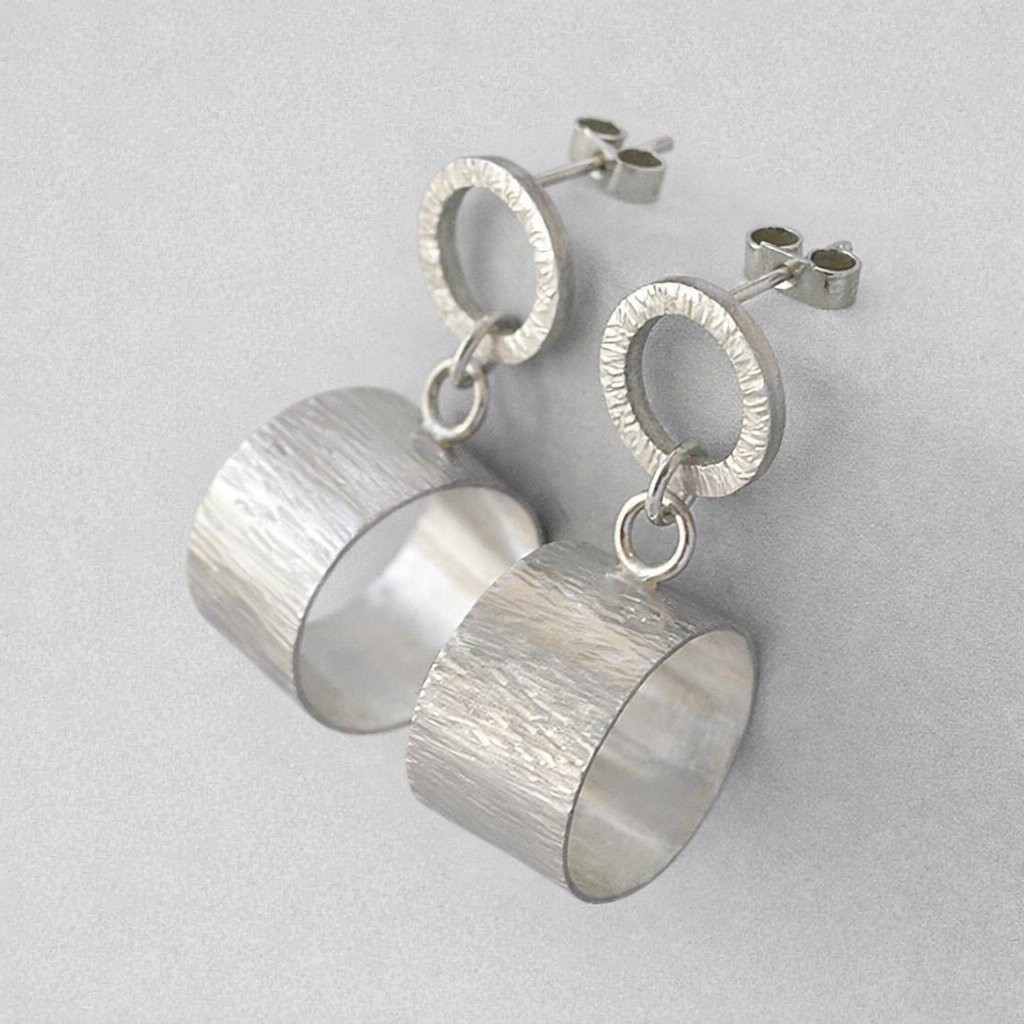 Sterling silver hammered circle stud earrings.