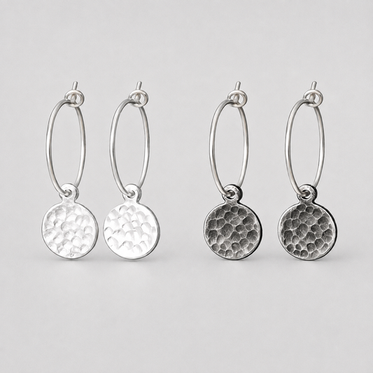 Hammered sterling silver disc charm hoop earrings.