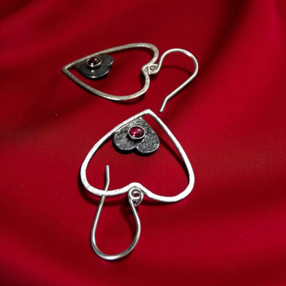 Sterling silver garnet heart earrings.