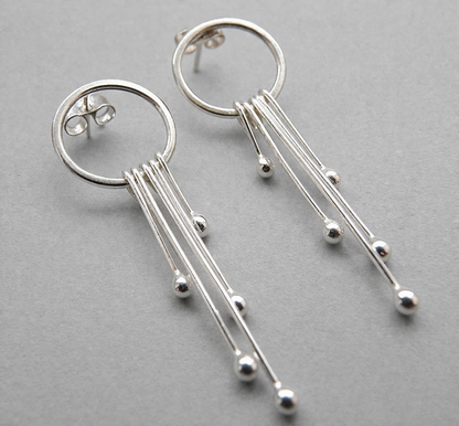 Long sterling silver circle stud earrings.