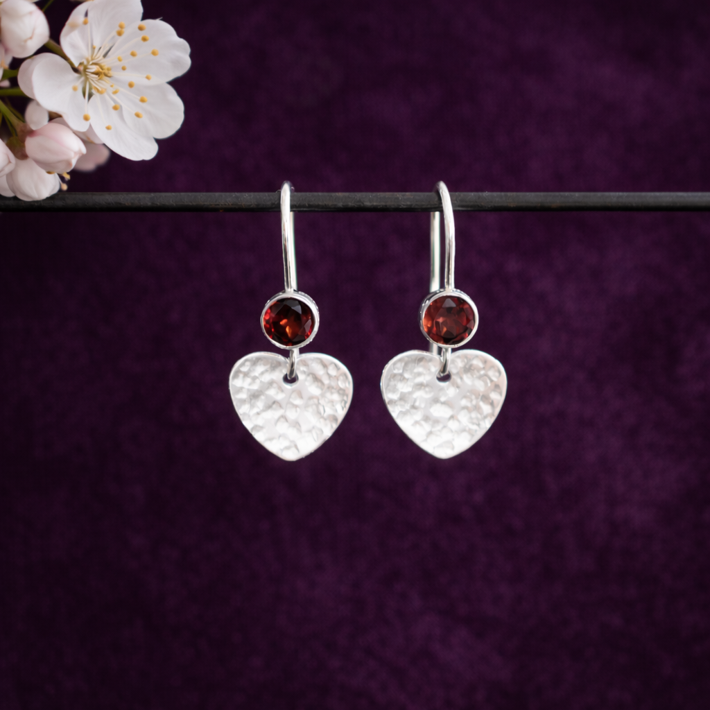 Garnet sterling silver heart dangle earrings.