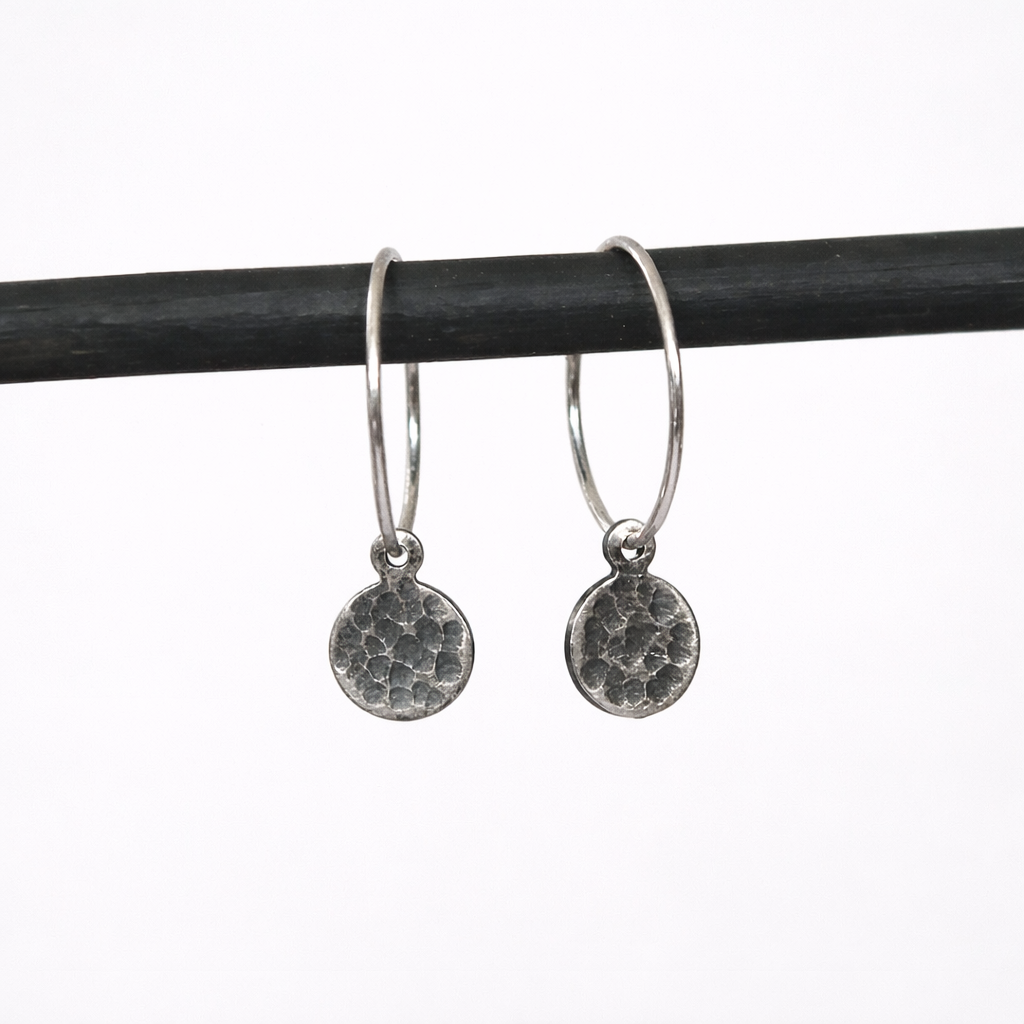Hammered sterling silver disc charm hoop earrings.