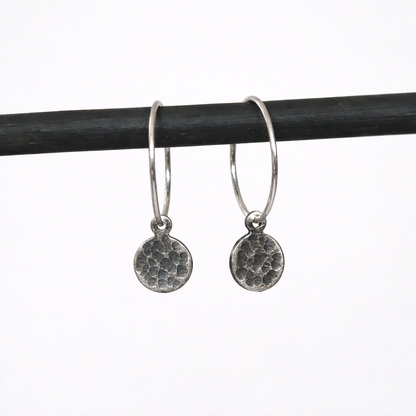 Hammered sterling silver disc charm hoop earrings.
