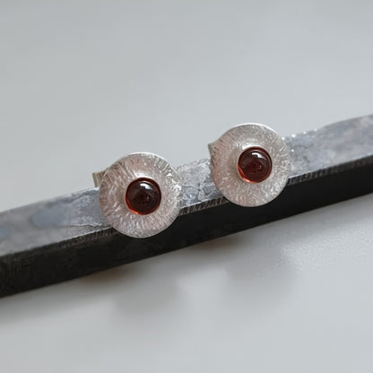Garnet sterling silver disc stud earrings.