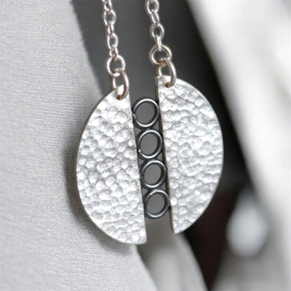 Sterling silver textured circle pendant necklace.
