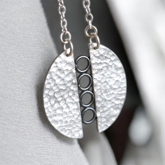 Sterling silver textured circle pendant necklace.