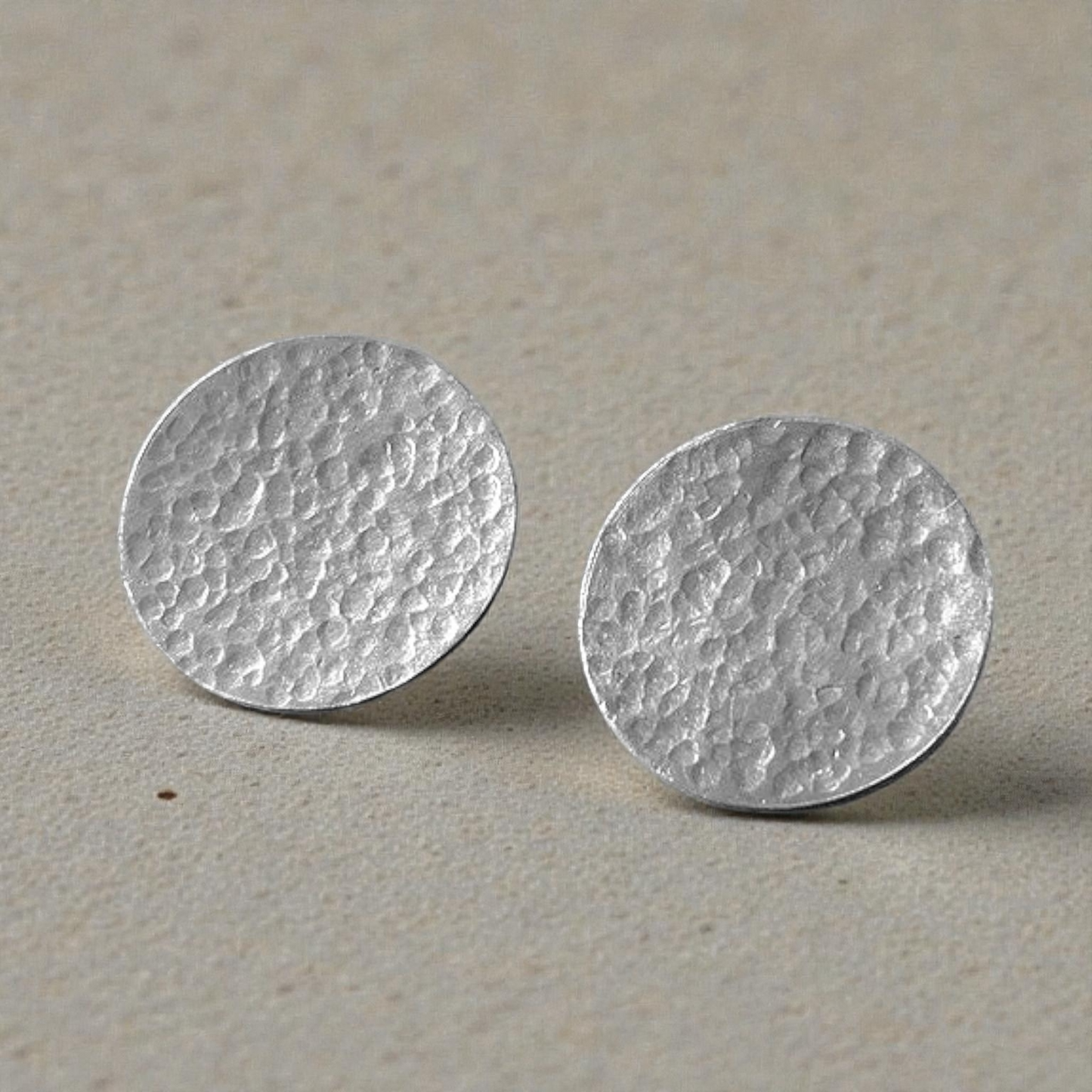 Minimalist sterling silver hammered disc stud earrings.