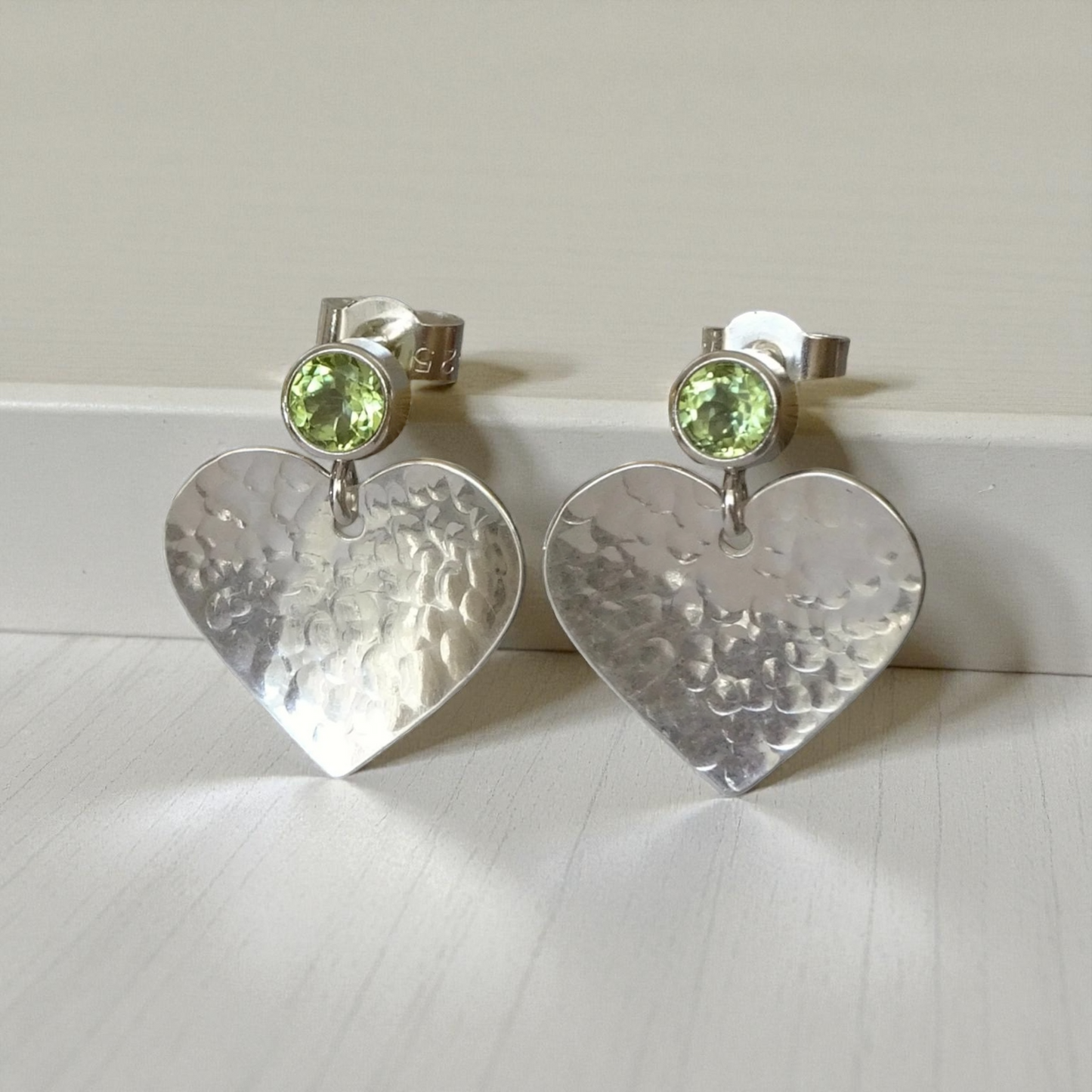Peridot August birthstone sterling silver heart stud earrings.