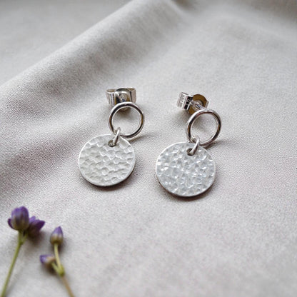 Sterling silver circle and hammered disc stud earrings.