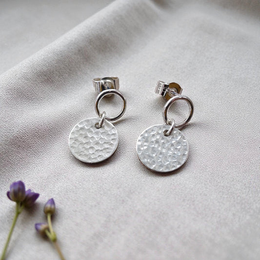 Sterling silver circle and hammered disc stud earrings.
