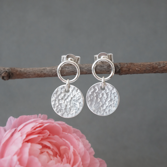 Sterling silver circle and hammered disc stud earrings.