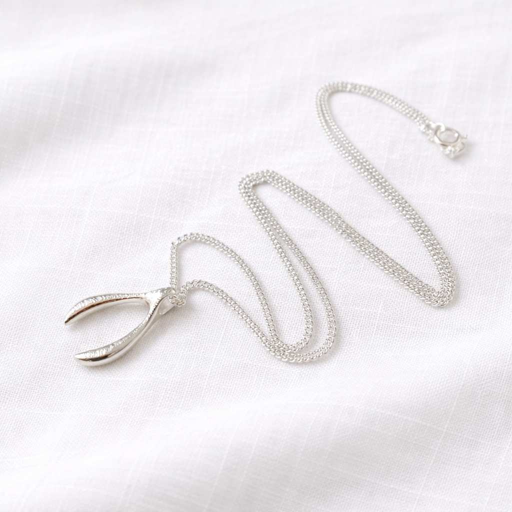 Sterling silver textured wishbone necklace.