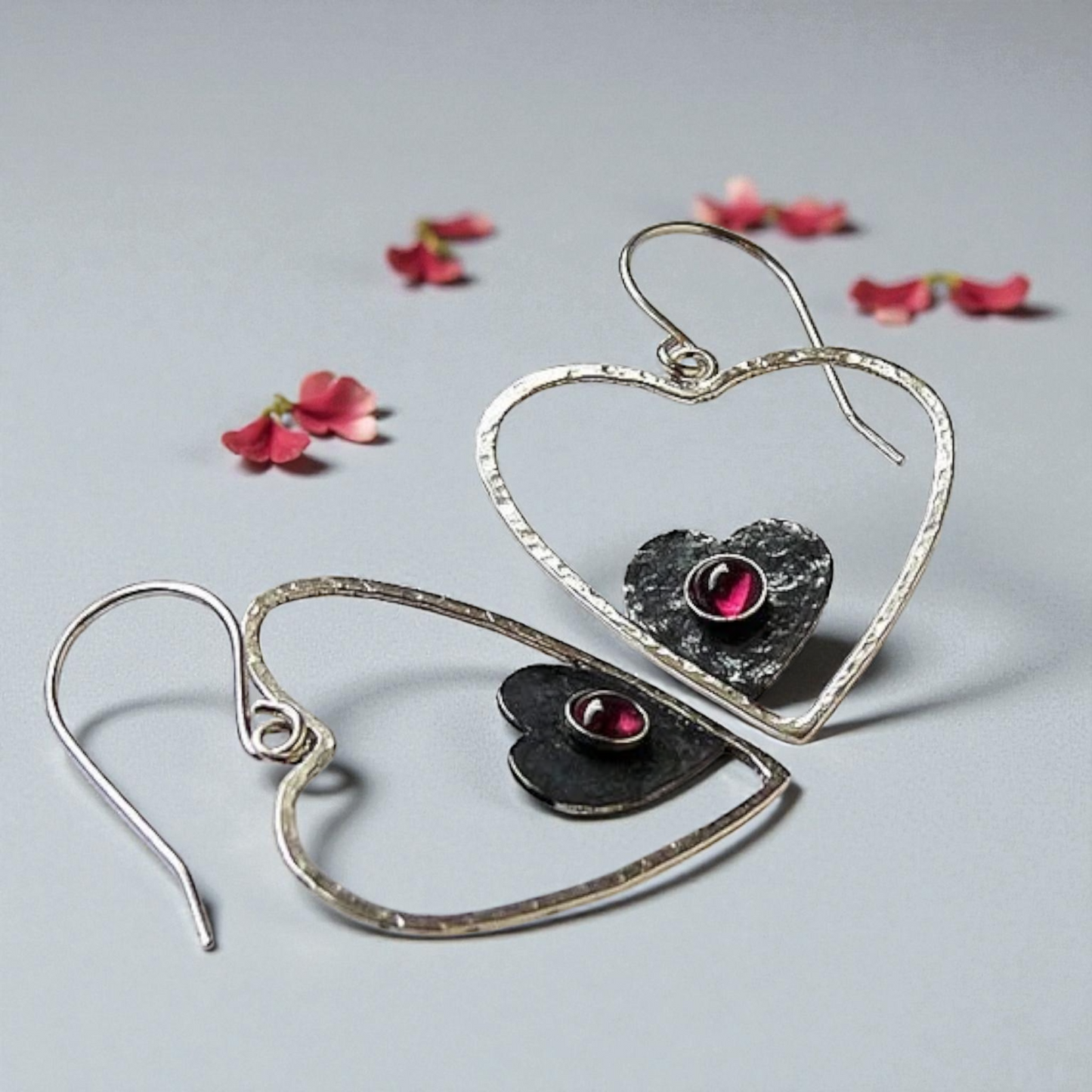 Sterling silver garnet heart earrings.