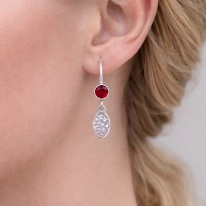 Garnet birthstone sterling silver dangle textured oval earrings.