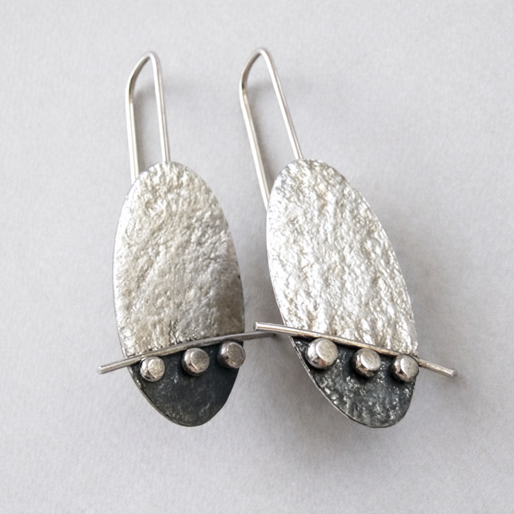 Artisan oval sterling silver drop earrings.