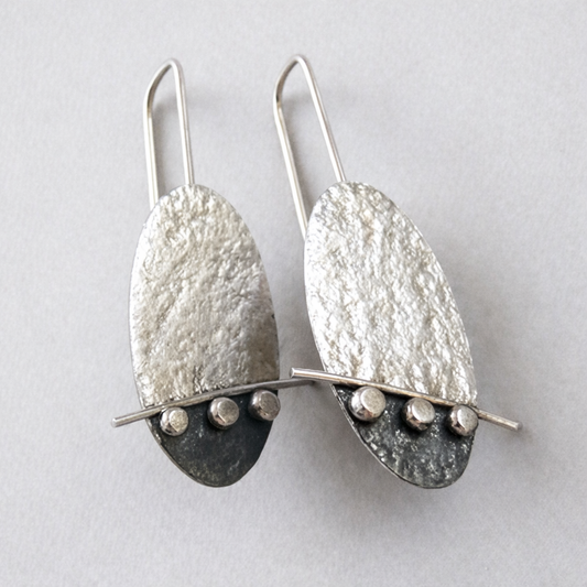 Artisan oval sterling silver drop earrings.