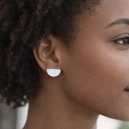 Hammered semicircle sterling silver stud earrings.