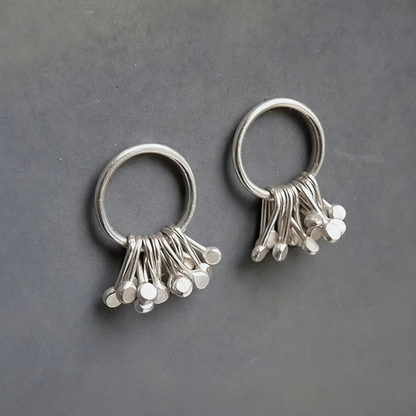 Sterling silver circle and droplets stud earrings.