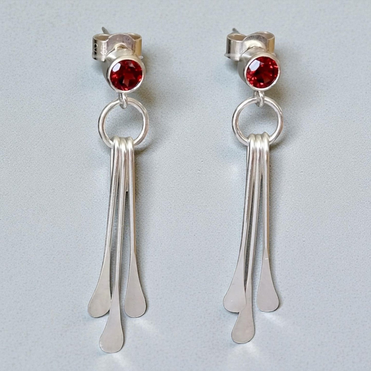 Garnet sterling silver dangle stud earrings.