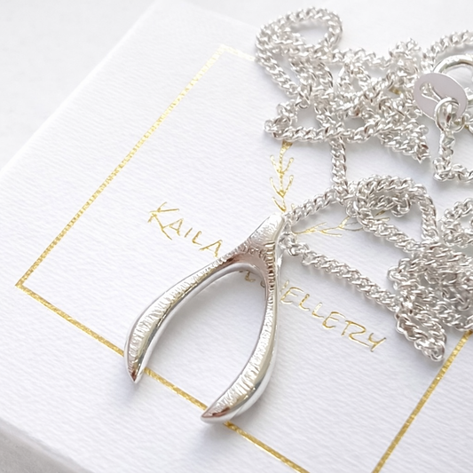 Sterling silver textured wishbone necklace.