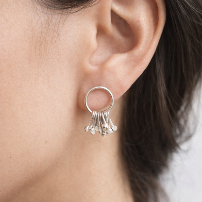 Sterling silver circle and droplets stud earrings.