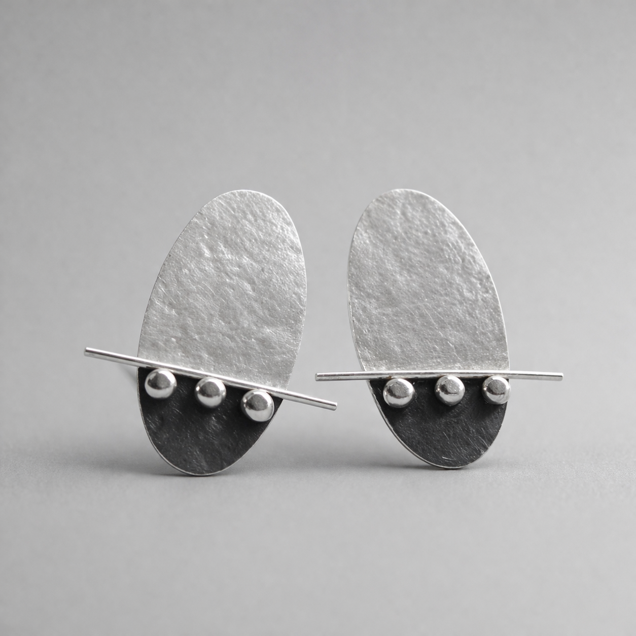 Sterling silver oval textured stud earrings. Oxidised earrings.