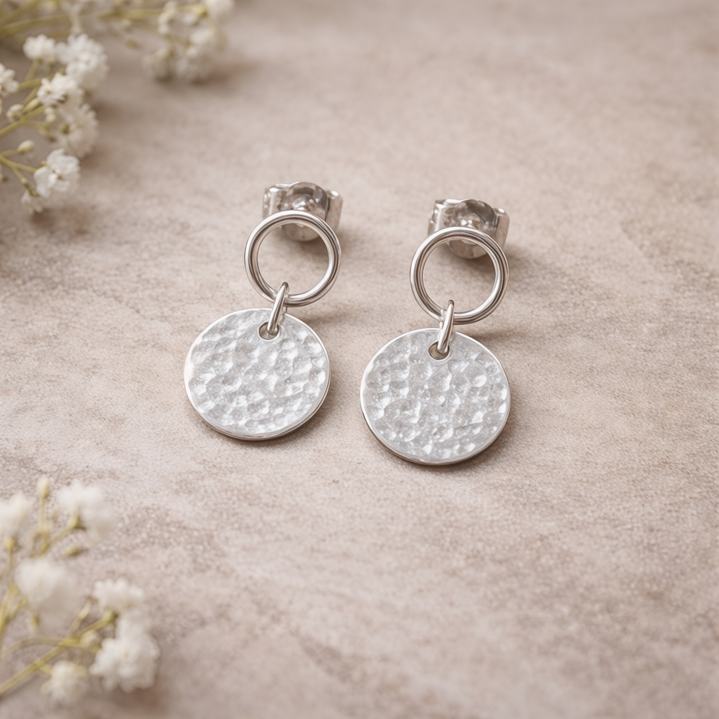 Sterling silver circle and hammered disc stud earrings.
