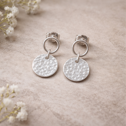 Sterling silver circle and hammered disc stud earrings.