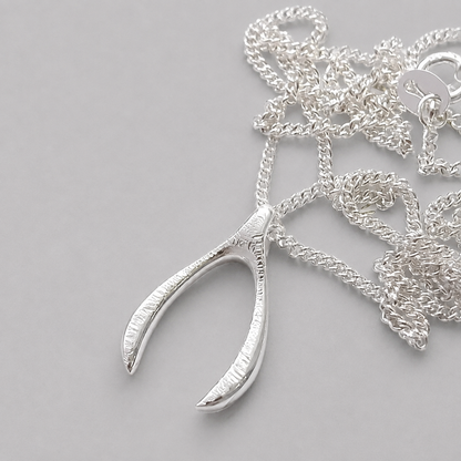 Sterling silver textured wishbone necklace.