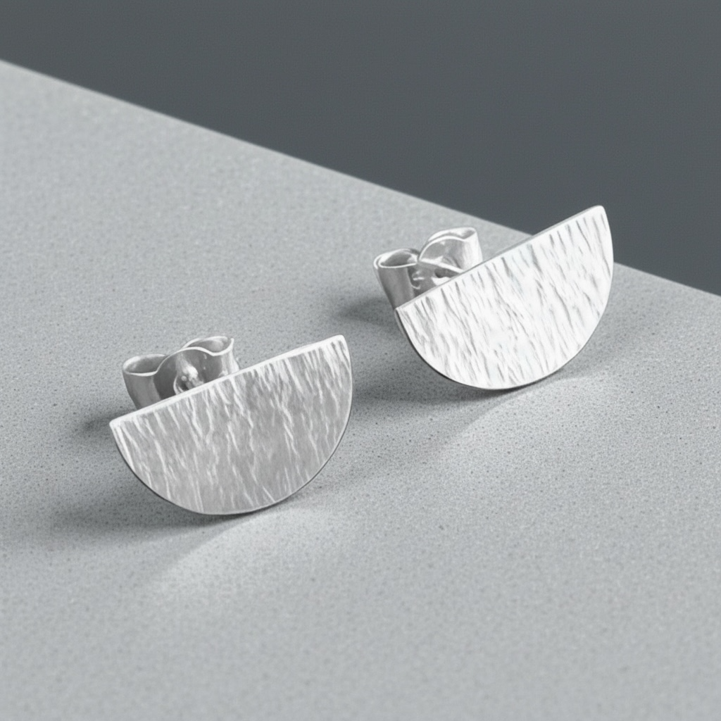 Hammered semicircle sterling silver stud earrings.